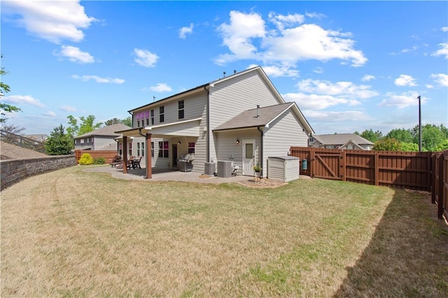 rear view of house featuring a fenced backyard, a patio, a lawn, and central air condition unit