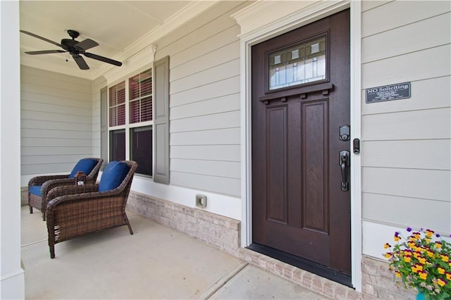 entrance to property featuring ceiling fan and a porch