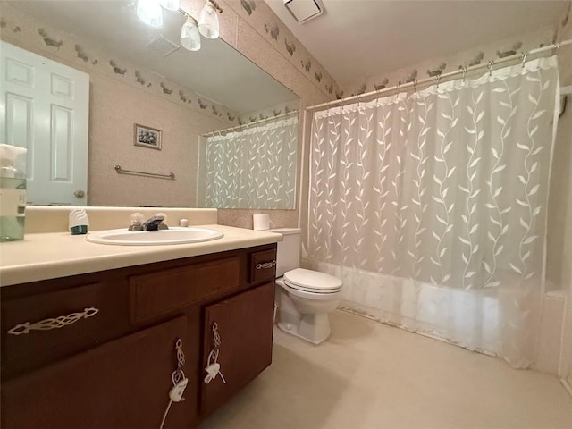 bathroom featuring vanity, shower / bath combo with shower curtain, and toilet
