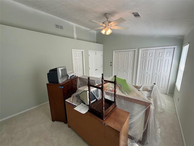 office space with visible vents, a ceiling fan, baseboards, and lofted ceiling