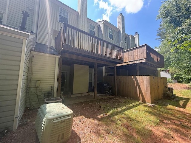 back of house featuring a deck and a chimney