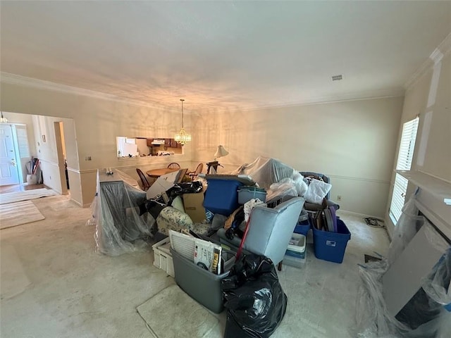 interior space with crown molding, carpet, and a chandelier