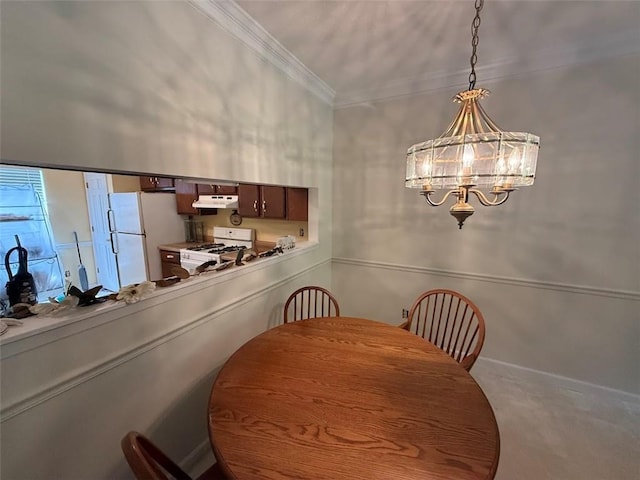 carpeted dining space featuring ornamental molding and a notable chandelier