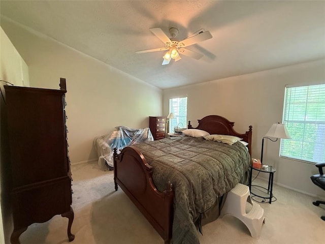 bedroom featuring a ceiling fan, baseboards, and light colored carpet