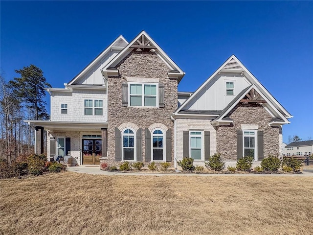 craftsman inspired home featuring covered porch and a front lawn