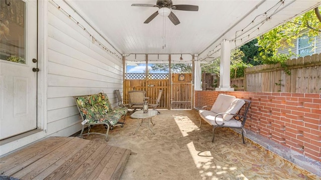 unfurnished sunroom featuring ceiling fan