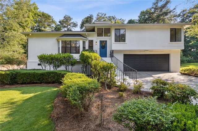 2010 Barnes Mill Rd, Marietta, GA 30062 - view of front of house featuring an attached garage, stucco siding, driveway, and a front yard