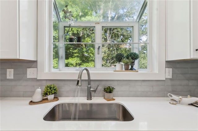 2010 Barnes Mill Rd, Marietta, GA 30062 - kitchen featuring light countertops, white cabinets, and backsplash