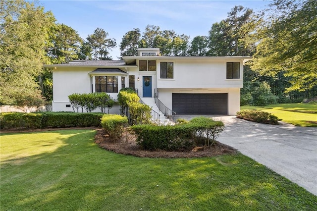 2010 Barnes Mill Rd, Marietta, GA 30062 - tri-level home featuring a garage, stucco siding, driveway, and a front yard