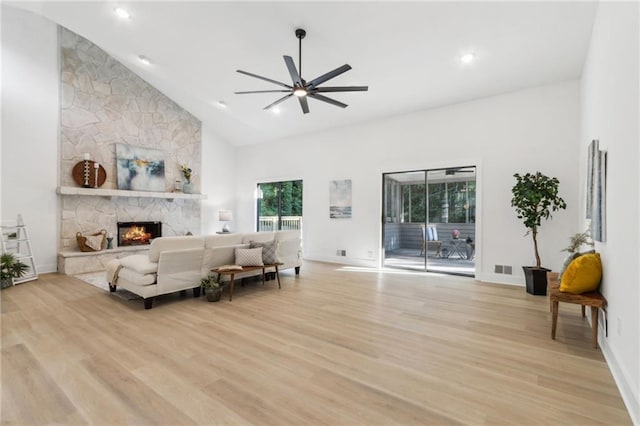 2010 Barnes Mill Rd, Marietta, GA 30062 - living area featuring ceiling fan, a stone fireplace, high vaulted ceiling, light wood-type flooring, and recessed lighting