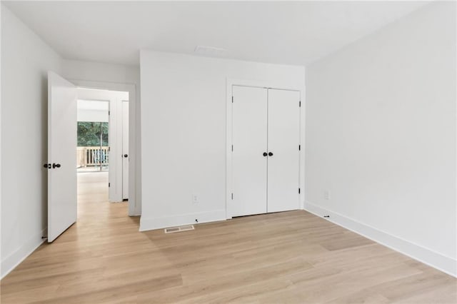 2010 Barnes Mill Rd, Marietta, GA 30062 - unfurnished bedroom with light wood-style flooring and a closet