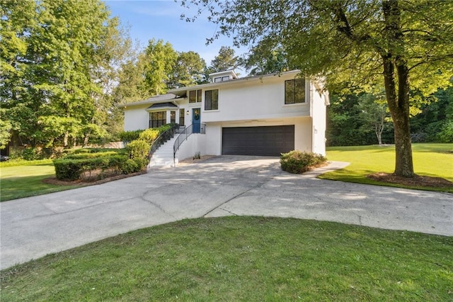 2010 Barnes Mill Rd, Marietta, GA 30062 - tri-level home with stucco siding, an attached garage, driveway, and a front yard