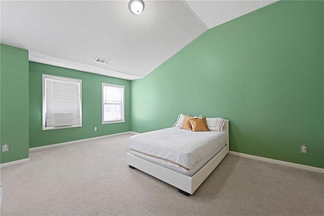 bedroom with vaulted ceiling and carpet