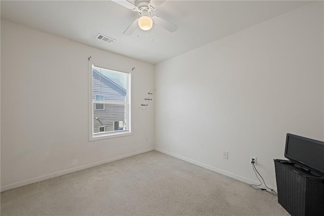 empty room with light colored carpet and ceiling fan