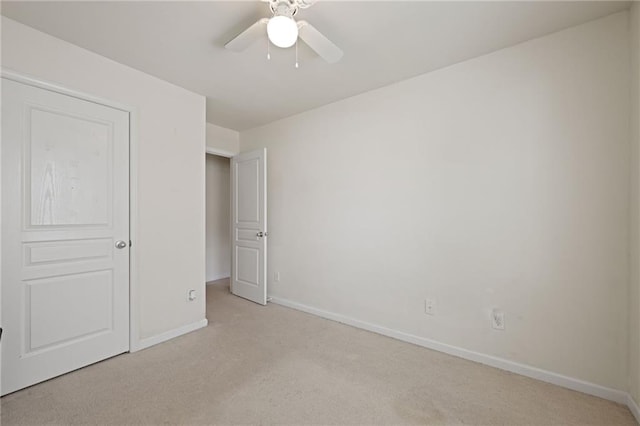 unfurnished bedroom with light colored carpet and ceiling fan