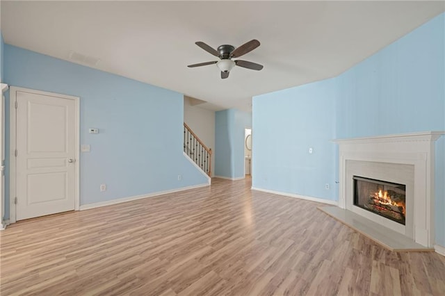 unfurnished living room with ceiling fan and light wood-type flooring