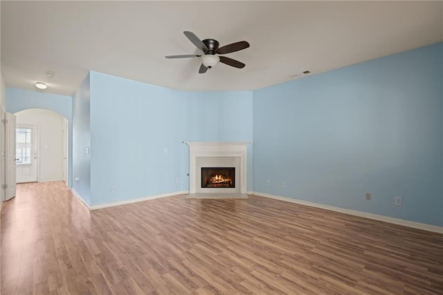 unfurnished living room with ceiling fan and light hardwood / wood-style floors