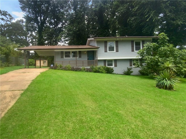 tri-level home featuring a carport and a front lawn