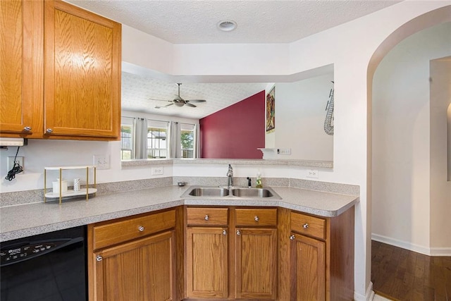 7057 Silver Bend Ovrlk, Austell, GA 30168 - kitchen featuring dishwasher, arched walkways, brown cabinets, a ceiling fan, and wood finished floors