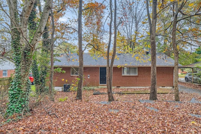 view of property exterior with crawl space, central AC, and brick siding