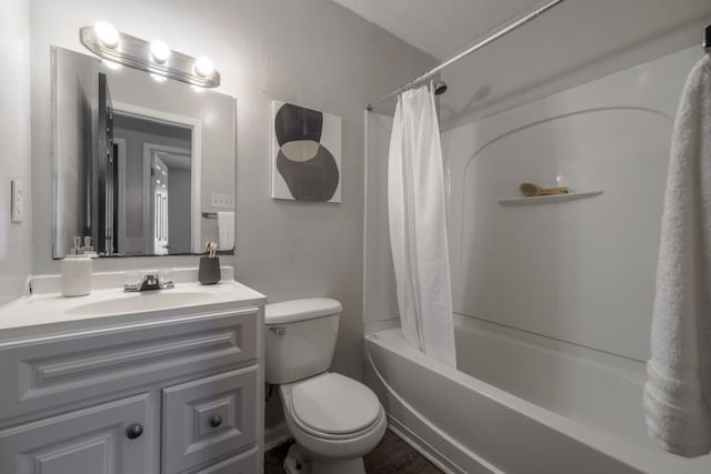 bathroom with toilet, shower / tub combo, and vanity