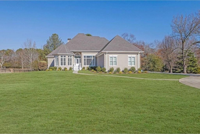 view of front of house with a front lawn and stucco siding