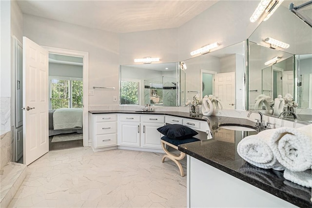 full bath featuring a stall shower, marble finish flooring, ensuite bathroom, and vanity