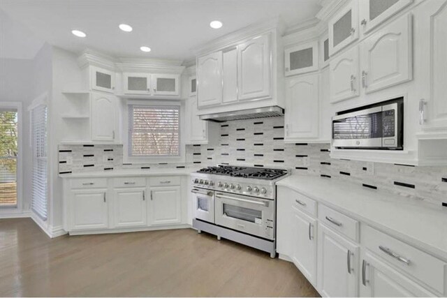 kitchen featuring open shelves, light wood-style flooring, stainless steel appliances, light countertops, and white cabinetry