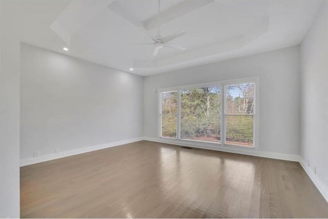 empty room with recessed lighting, ceiling fan, baseboards, and wood finished floors