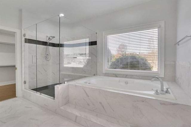 bathroom with a marble finish shower, marble finish floor, and a garden tub