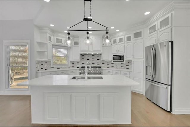 kitchen featuring stainless steel appliances, a sink, white cabinetry, light countertops, and recessed lighting