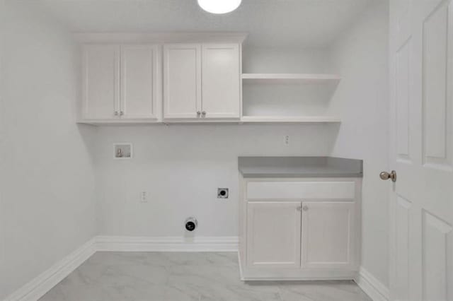 washroom with electric dryer hookup, baseboards, marble finish floor, and hookup for a washing machine