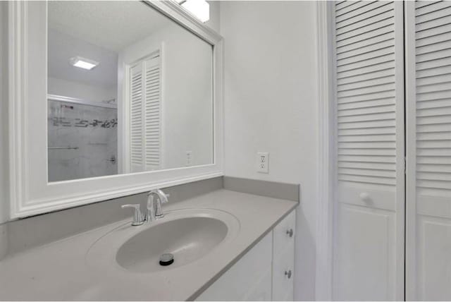 bathroom featuring a closet and vanity