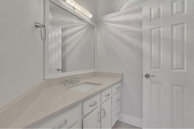 bathroom with vanity and baseboards