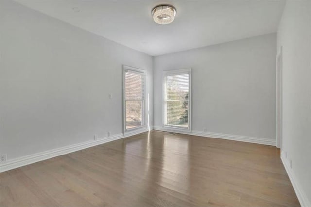 unfurnished room featuring wood finished floors and baseboards