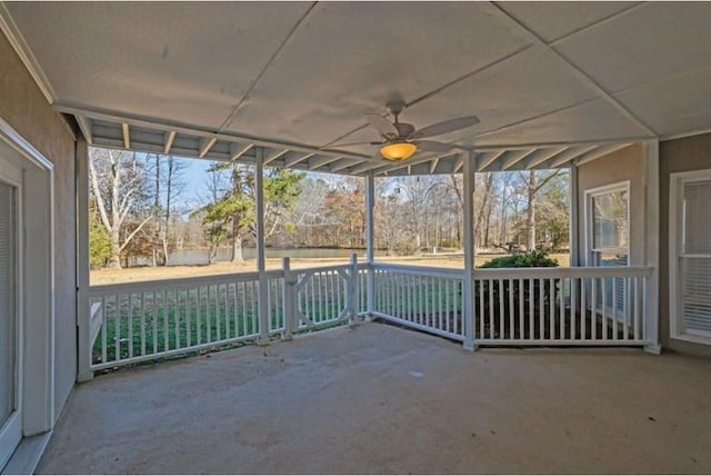 unfurnished sunroom with ceiling fan