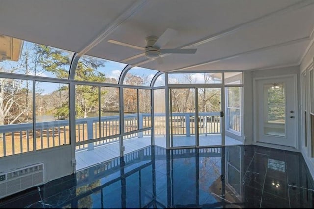 unfurnished sunroom with a ceiling fan and a wall mounted air conditioner