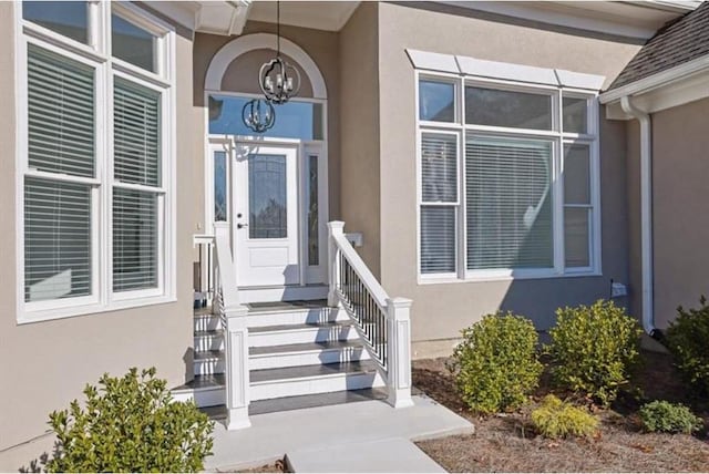 view of exterior entry with stucco siding