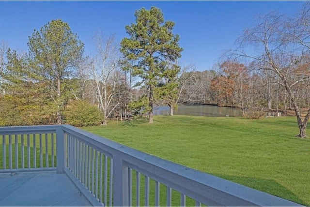 wooden deck featuring a yard and a water view