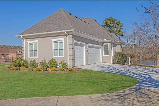 view of side of home with a shingled roof, concrete driveway, a lawn, stucco siding, and an attached garage