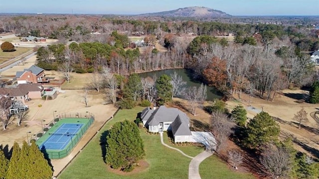 aerial view featuring a view of trees and a water and mountain view