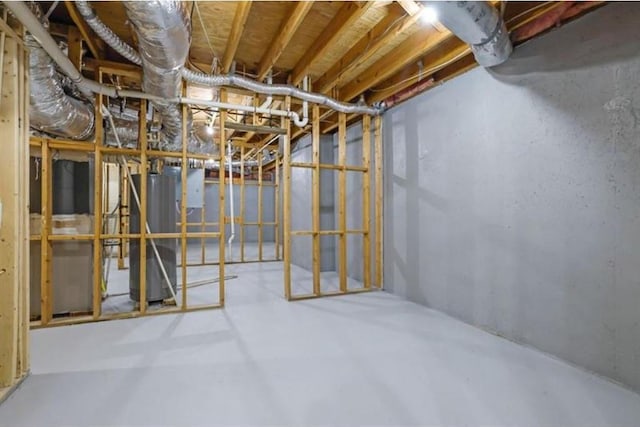 unfinished basement featuring gas water heater
