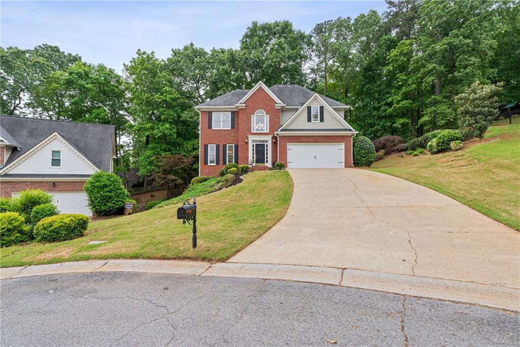 1988 Claiborne Ct, Marietta, GA 30062 - view of front of property with an attached garage, driveway, a front lawn, and brick siding