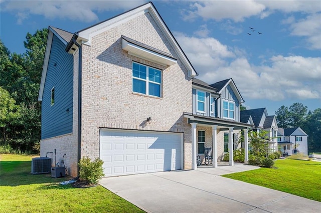 view of front of home with cooling unit, a garage, and a front lawn