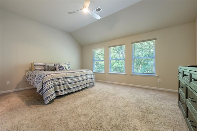 carpeted bedroom with vaulted ceiling and ceiling fan