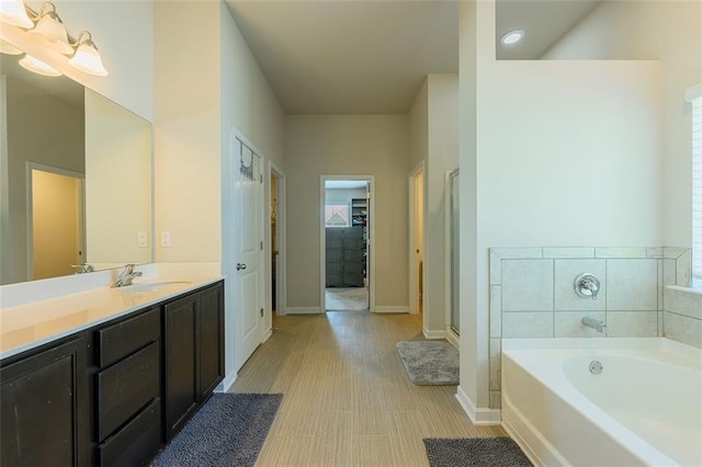 bathroom featuring vanity and plus walk in shower