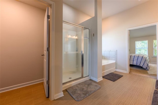 bathroom featuring separate shower and tub and hardwood / wood-style floors