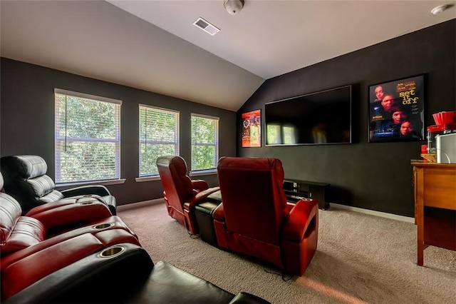 carpeted cinema room with lofted ceiling