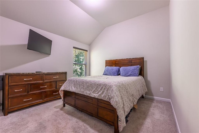 carpeted bedroom featuring lofted ceiling