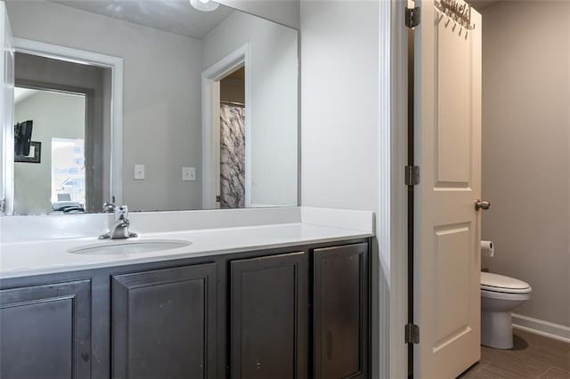 bathroom with vanity, hardwood / wood-style floors, and toilet